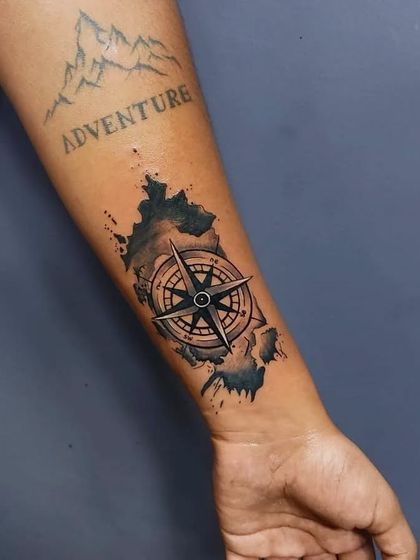 This client had an old "Adventure" tattoo that they wanted to incorporate into a new piece. We designed this compass and map tattoo to cover the old work and give it a new story.