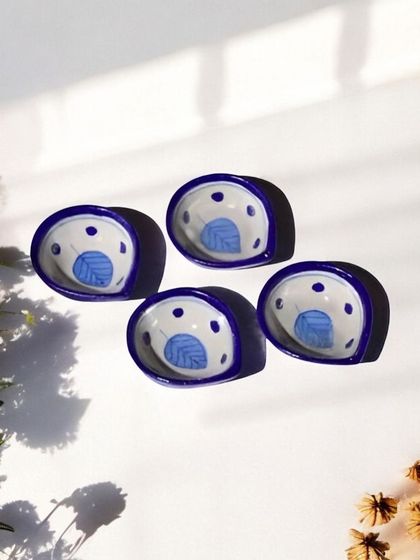 These small, hand-painted ceramic bowls are perfect as roli-chawal holders or for serving small prasad. The delicate blue leaf design adds a touch of elegance to your pooja thali.
