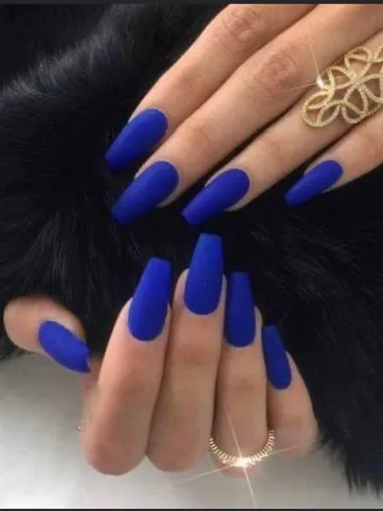 A bold, matte royal blue manicure. The matte top coat gives these long coffin nails a modern, velvety finish that is very eye-catching.