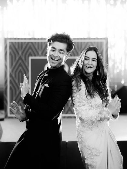 That back-to-back pose is a classic for a reason. It's a moment of pure fun and chemistry, captured here with Seerat and her partner during their sangeet in London.