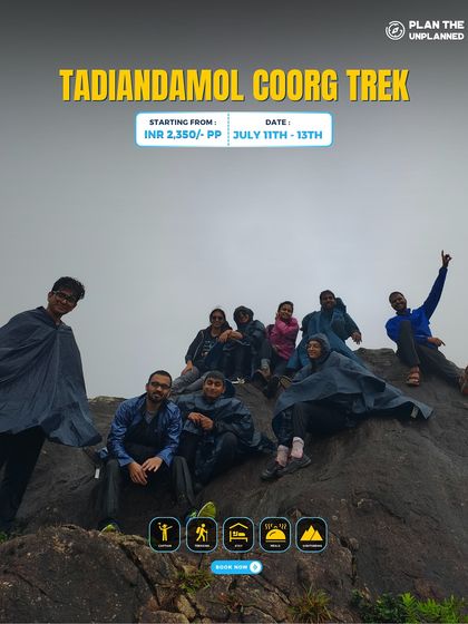 A group in raincoats on the Tadiandamol Coorg trek, ready for the misty weather.
