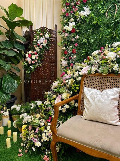 Another view of the botanical garden baby shower, showing how we used potted plants, candles, and a carved wooden screen to create a lush and layered look.