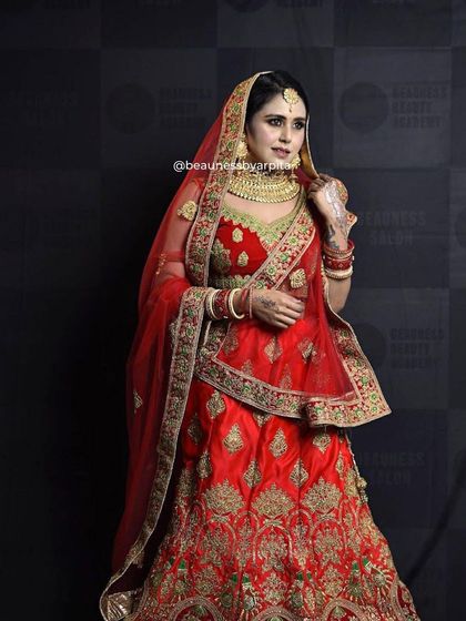 A closer look at the detailed craftsmanship of our rental bridal lehengas. This red and gold outfit is a perfect example of the quality and richness we offer.