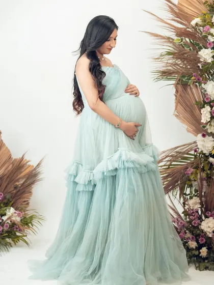 A beautiful portrait in our light green Eva gown. The ruffled details and flowing tulle create a soft and romantic look.
