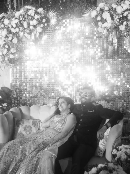 A relaxed and happy moment between the couple during their cocktail party. This black and white shot captures their easy chemistry as they enjoy the celebration.