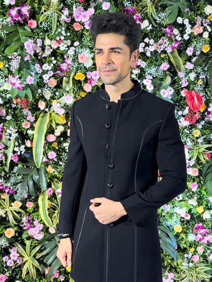 Dressed in Dawood Khan, actor Piyush Sahdev proves that style is timeless. He wears a sleek, black Indo-Western suit with subtle piping details.