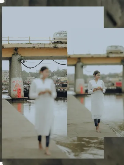 A candid-style shot of a devotee walking barefoot by the river, blending the spiritual journey with the surrounding urban landscape.