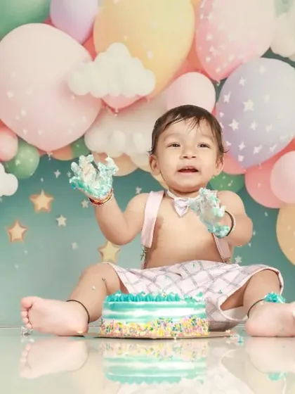 The aftermath of a successful cake smash! This little one is covered in frosting and happiness, making for a memorable first birthday photo.
