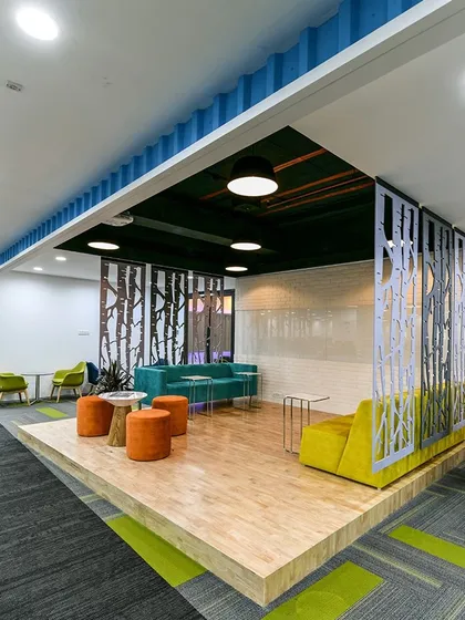 A collaboration area on a raised wooden platform, which can also double as a stage for presentations or events.