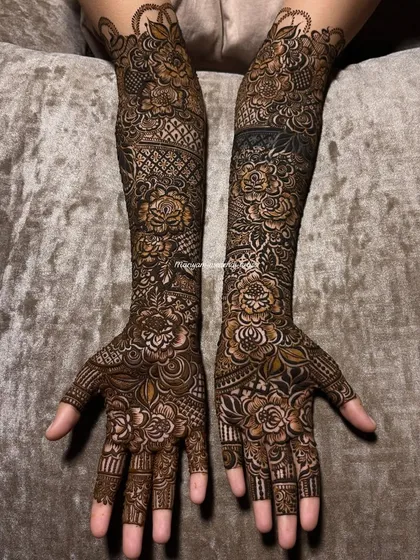 My signature Dubai-style floral designs are a favourite among brides. I focus on creating bold, 3D roses with delicate shading to make the pattern pop, covering the arms fully for a grand look.