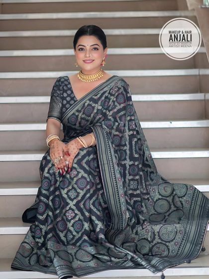 A full view of the elegant party look. The simple gold choker and clean makeup let the beautiful saree shine.