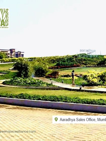 The expansive, contoured lawns at the Aaradhya Sales Office provide a sense of openness and serenity. This landscape design gives potential buyers a preview of the spacious and green lifestyle they can expect from the development.