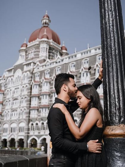 A duplicate of image 59, this shot perfectly frames the couple's tender moment with the majestic Taj Mahal Palace Hotel as the backdrop.