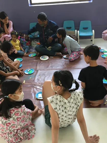 Arts and crafts are a key part of my camps. Here, children are gathered for a creative session, where they can express themselves and develop fine motor skills.