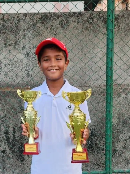 Aarav Chhallani with his trophies for winning the singles and finishing runner-up in doubles at the All India National Series at the Sania Mirza Tennis Academy.