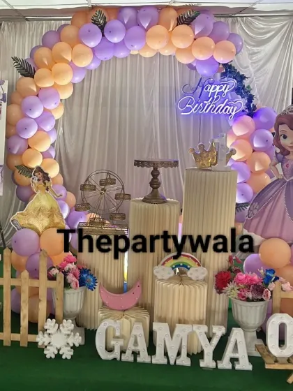 A simple and sweet Princess Sofia theme with a beautiful balloon arch and a personalized photo board celebrating the birthday girl's first year.