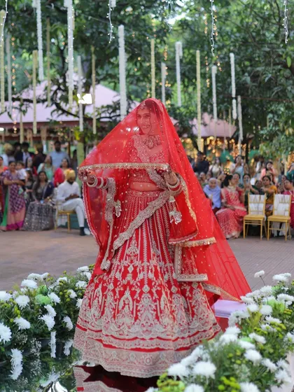 The grand bridal entry. Jigisha's look was all about timeless elegance in a classic red lehenga.