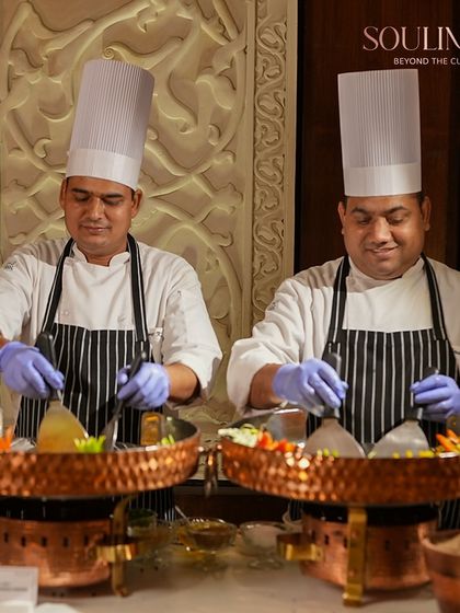 Two of our chefs at a live Tawa station, ready to serve guests with freshly prepared delicacies. Our interactive counters are a highlight of any social gathering.