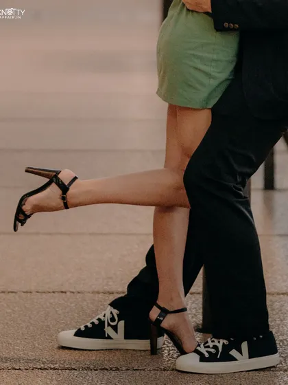 Sometimes the story is in the details. This close-up on their footwear and the playful leg kick adds a fun, quirky element to their Sydney pre-wedding shoot, telling more about their personalities.