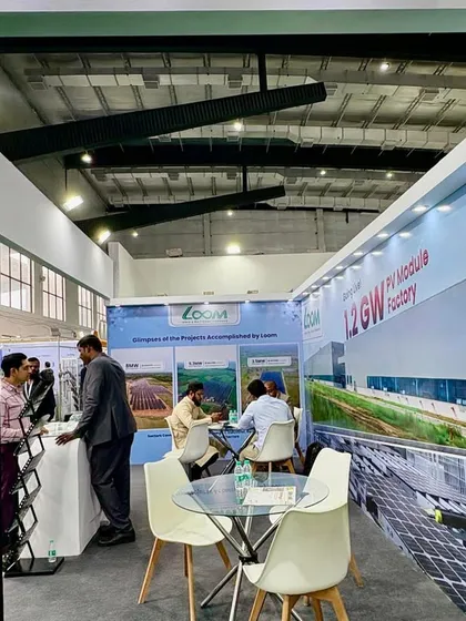 The professional setup of my booth at the expo, designed to showcase our brand and technology leadership. The backdrop highlights our upcoming 1.2 GW PV Module Factory.