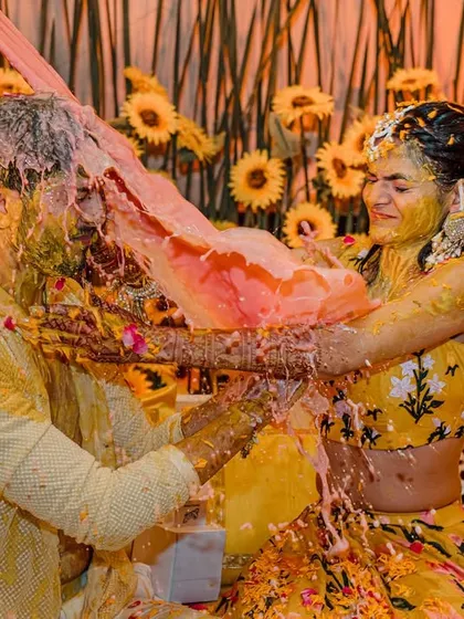 When the Haldi turns into a full-on celebration! This moment of playful chaos, with the couple being doused in turmeric and water, is what makes these ceremonies so special.