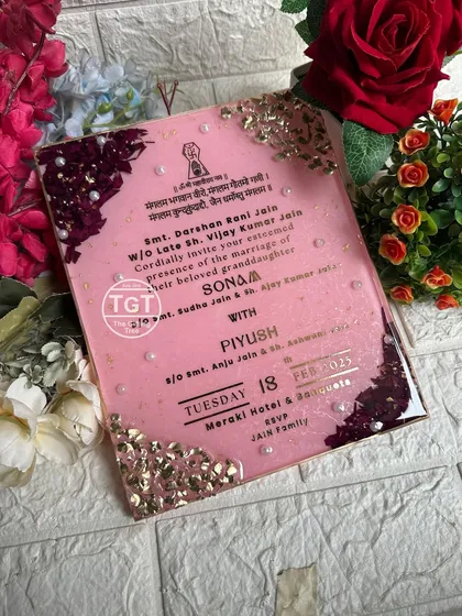 This shot, set against a floral background, highlights the invitation's luxurious and celebratory feel.