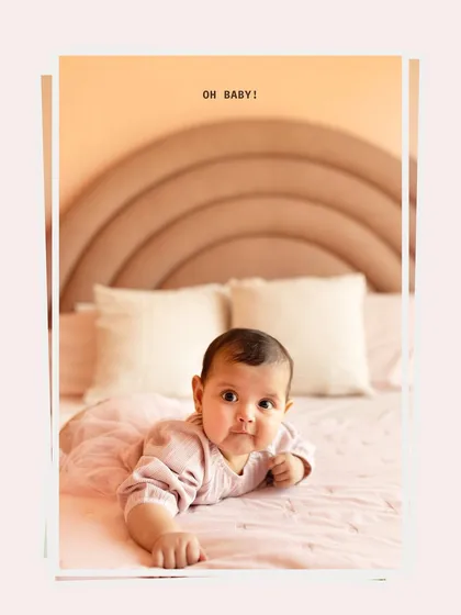 A sweet portrait of a baby girl during her milestone session, which also included her lovely older sister.