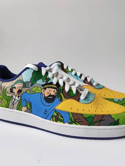 The other shoe in the pair is dedicated to Tintin, Captain Haddock, and Professor Calculus on one of their adventures. The art styles blend together seamlessly.