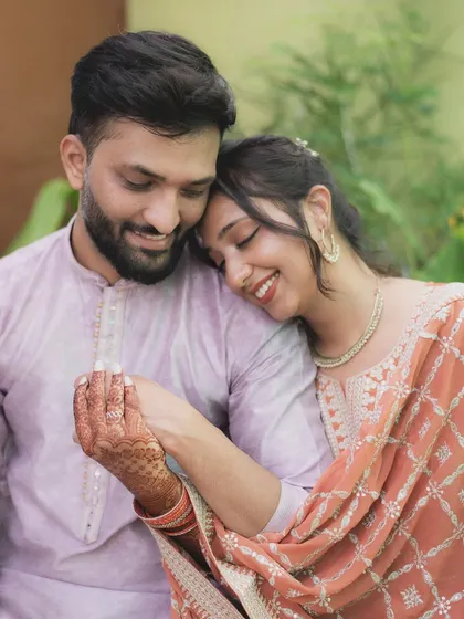 A tender moment where the bride-to-be rests her head on her partner's shoulder. This photo captures the trust, comfort, and affection they share.