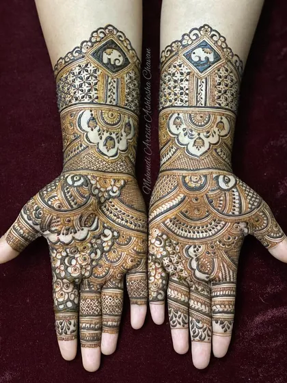 A beautiful example of Indian mehendi design. The hands are covered in a mix of floral, geometric, and elephant motifs, creating a rich and balanced composition.