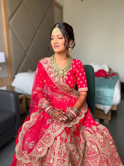 The full view of a minimal red bridal look. The bright red lehenga is balanced with soft, natural makeup for a fresh and modern feel.