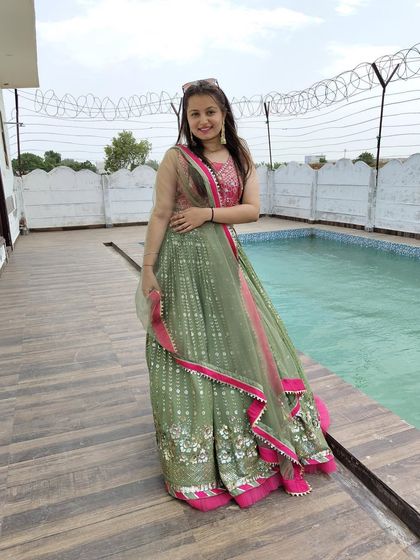 This mehendi-green lehenga with a pop of pink is a vibrant and fun choice for a pre-wedding function. It's light, comfortable, and easy to dance in.