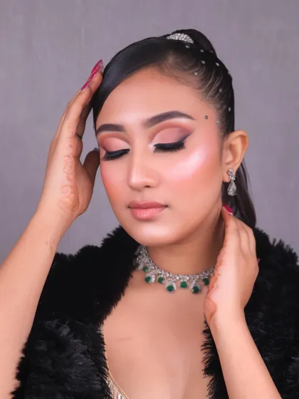 A close-up of the student's work, showing the perfectly blended eyeshadow and highlighted skin, demonstrating the quality of our training.