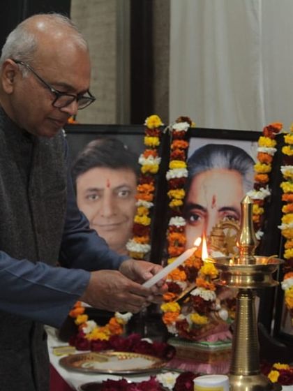 A senior guest lighting the ceremonial lamp, officially inaugurating the 'Raghunathanjali' musical evening.