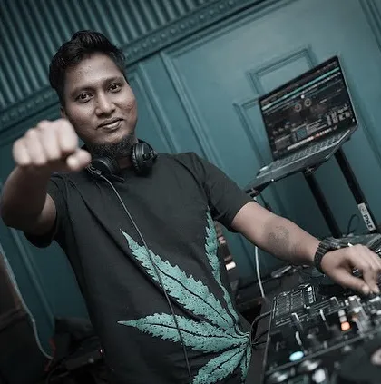A powerful shot from behind the decks, ready to drop the next beat. This is the moment of anticipation before the energy of a track is unleashed.