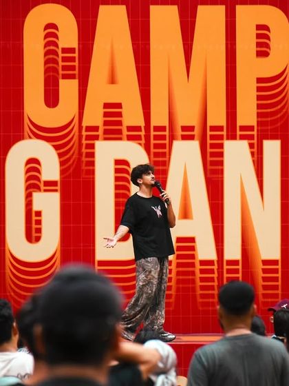 An instructor takes the mic, sharing insights and inspiration with hundreds of students. Our camp is not just about steps, it's about mentorship and connection.