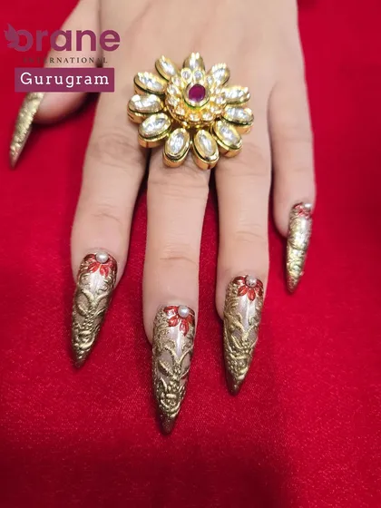 This shot highlights the rich gold chrome and delicate red details. I teach students to master these fine details for a truly professional finish.