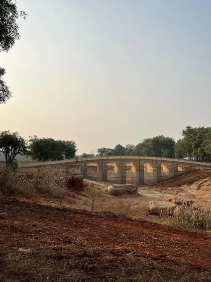 A mock-up for a bridge, designed by a collaborator and constructed from jute fabric, creates a striking installation on our site in Aziznagar. This artistic approach to prototyping helps us visualize the form and scale of a major landscape feature.
