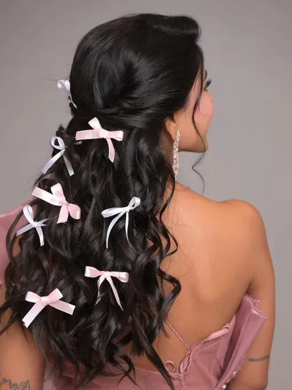 A side view of the bow-adorned hairstyle, showing how the accessories are scattered through the lengths of the hair for a dreamy effect.