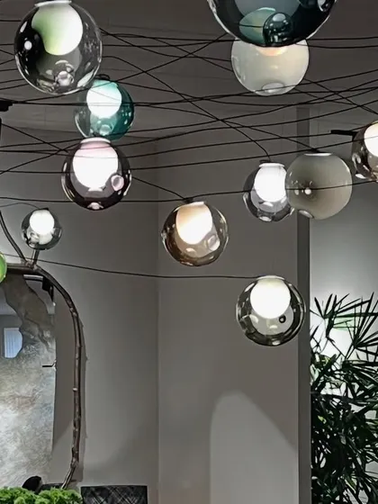 The Bocci 28 series, seen here in a dense, web-like installation at the India Art Fair. Each spherical pendant is a world of its own, with inner satellite shapes and a unique color composition.