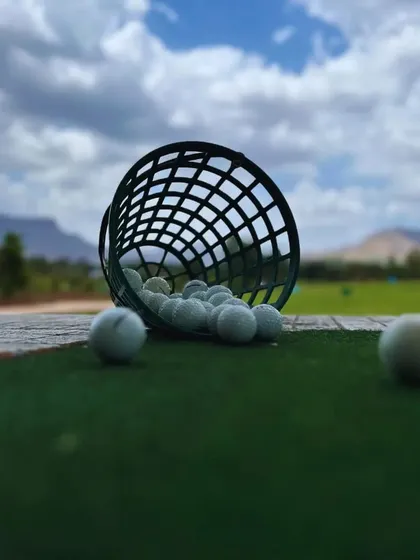A basket of golf balls ready for a practice session. Rain or shine, we're always ready to help you work on your game.