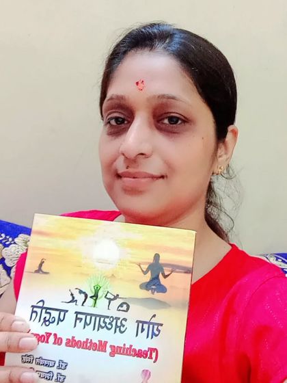A student proudly displaying my book. My aim in writing is to make the profound and often complex methods of teaching yoga simple and accessible for all aspiring teachers.