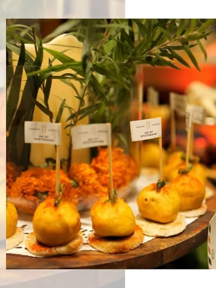 A close up of our mini vada pavs, garnished with a green chili. These small bites pack all the punch of the original Mumbai street food classic.