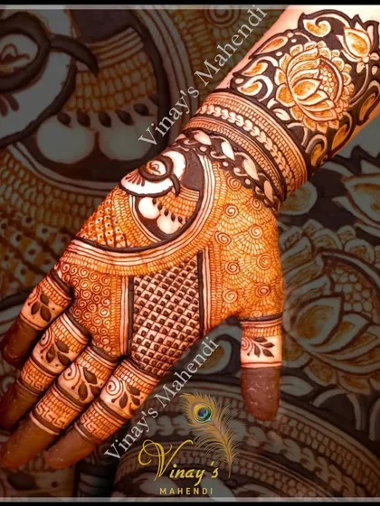 A close-up of a guest's hand with a detailed swan and floral design. The mix of patterns creates a rich texture.