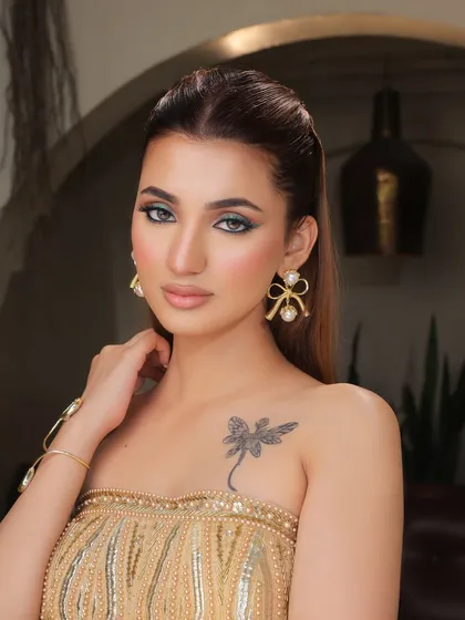 A close-up portrait showcasing the sharp green winged liner.