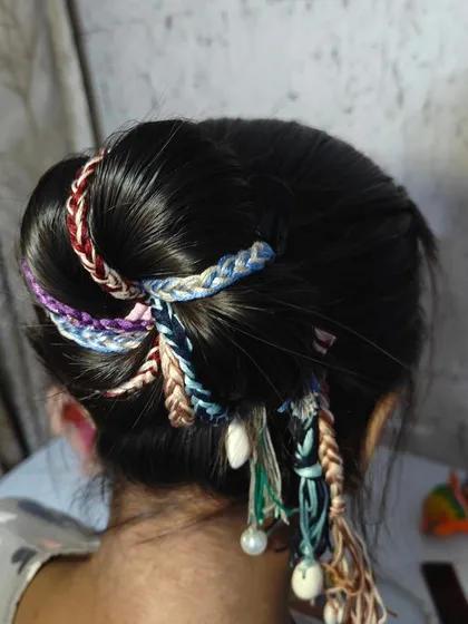 Another way to style the boho hair extensions in a bun. The different braids wrap around beautifully, creating a textured and eye-catching hairstyle.