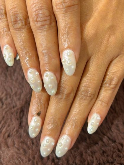 A beautiful and delicate set of pearly white nails with 3D pearl accents scattered like raindrops.