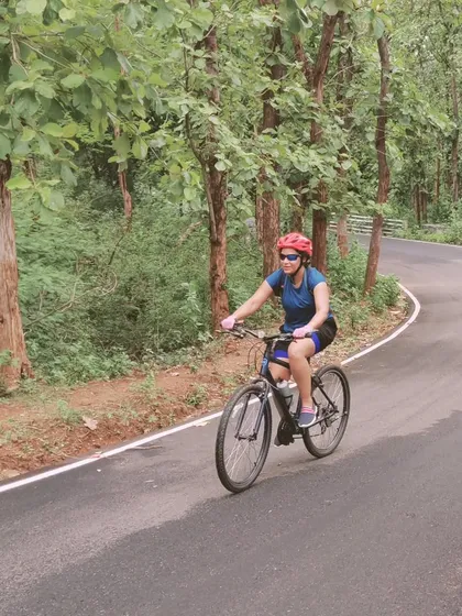A rider enjoying a smooth, forested section of our 'Tour of Kodai'. Our tours are designed for all kinds of cyclists, with routes that offer both challenging climbs and pleasant, rolling stretches.