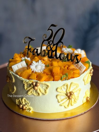 Celebrating "50 & Fabulous" with my seasonal Mango Maharaja cake. It's loaded with fresh mangoes and decorated with a custom topper, making it a perfect centerpiece for a milestone birthday.