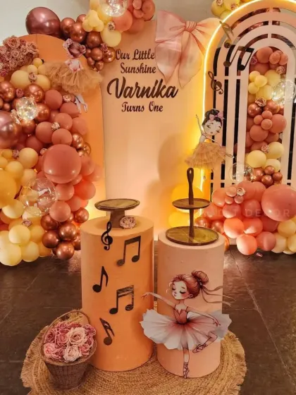 The full setup for the ballerina first birthday, showing the beautiful arch backdrop, balloon garlands, and themed props.